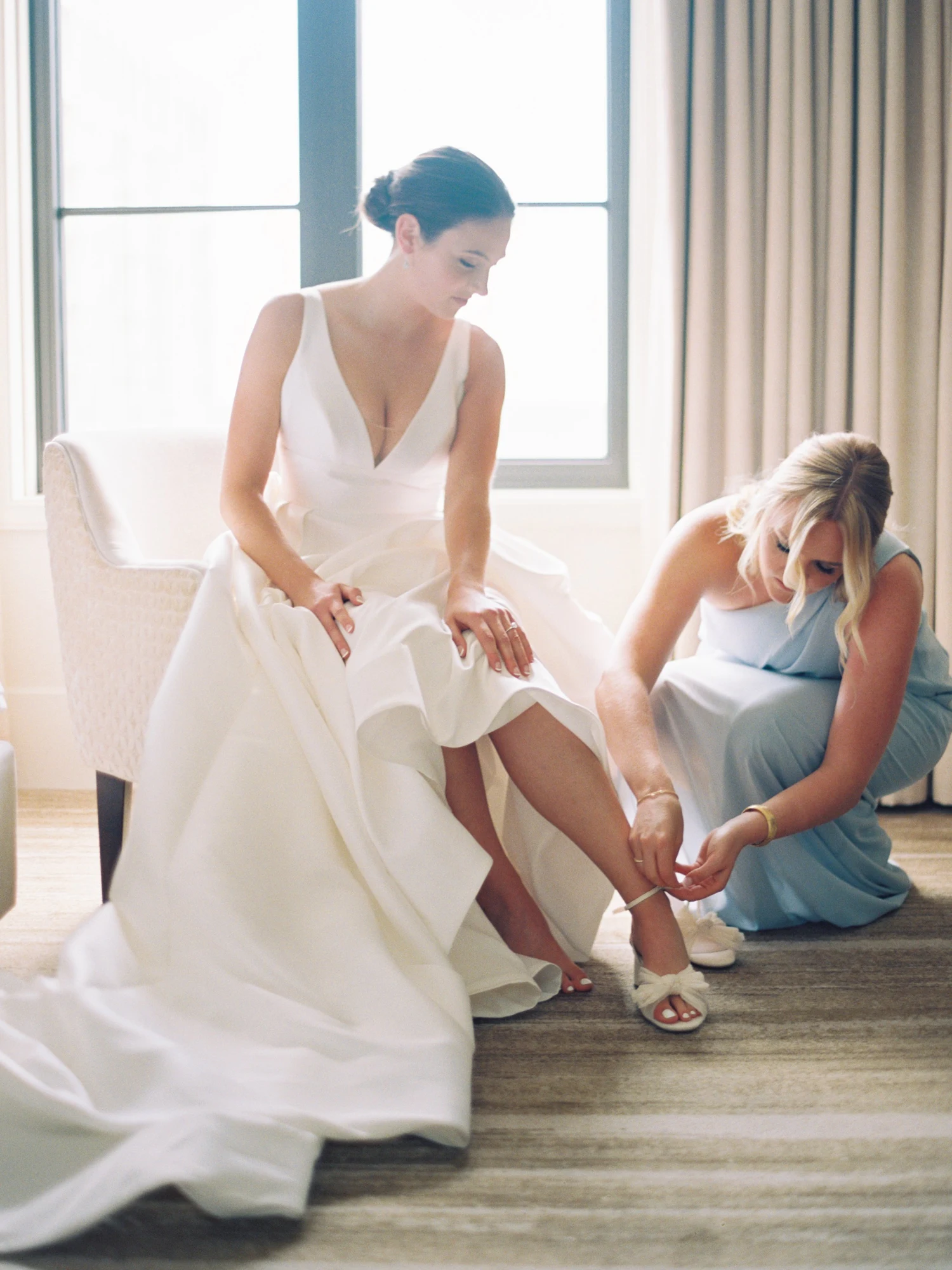 A bride getting ready with someone close to her